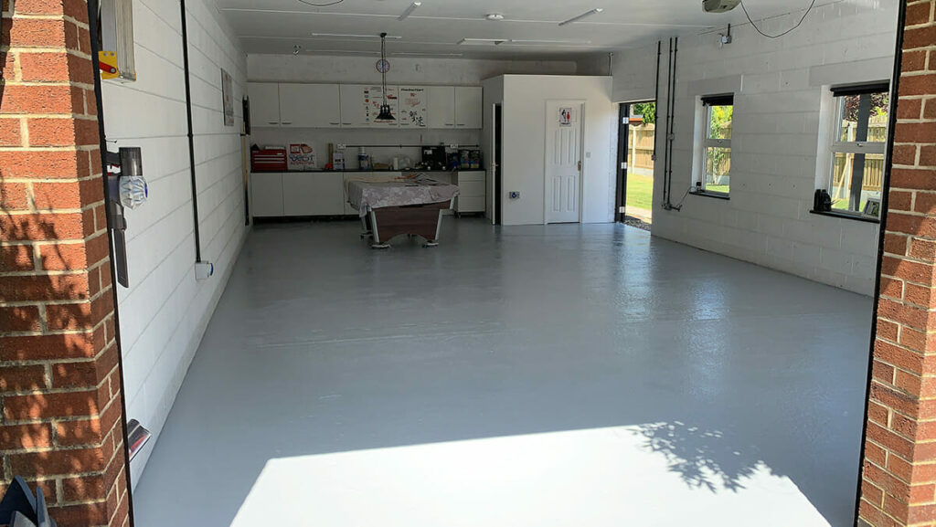 Light gray garage floor paint applied to residential concrete garage floor.