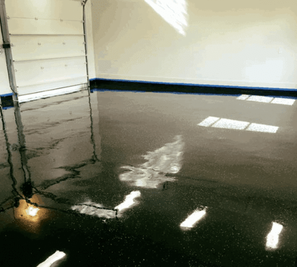 Glossy epoxy garage floor coating installed in residential garage.