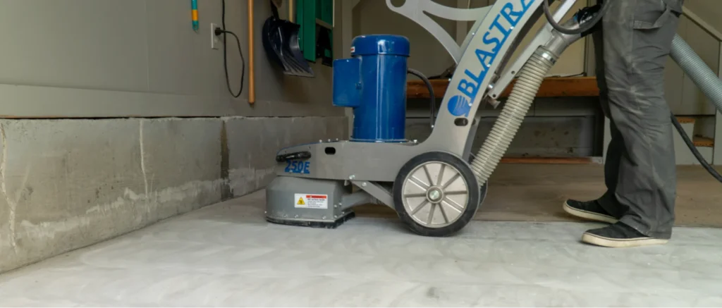 Kansas City garage floor coating contractor using Blastrac 250E diamond grinder to prep concrete slab before epoxy application